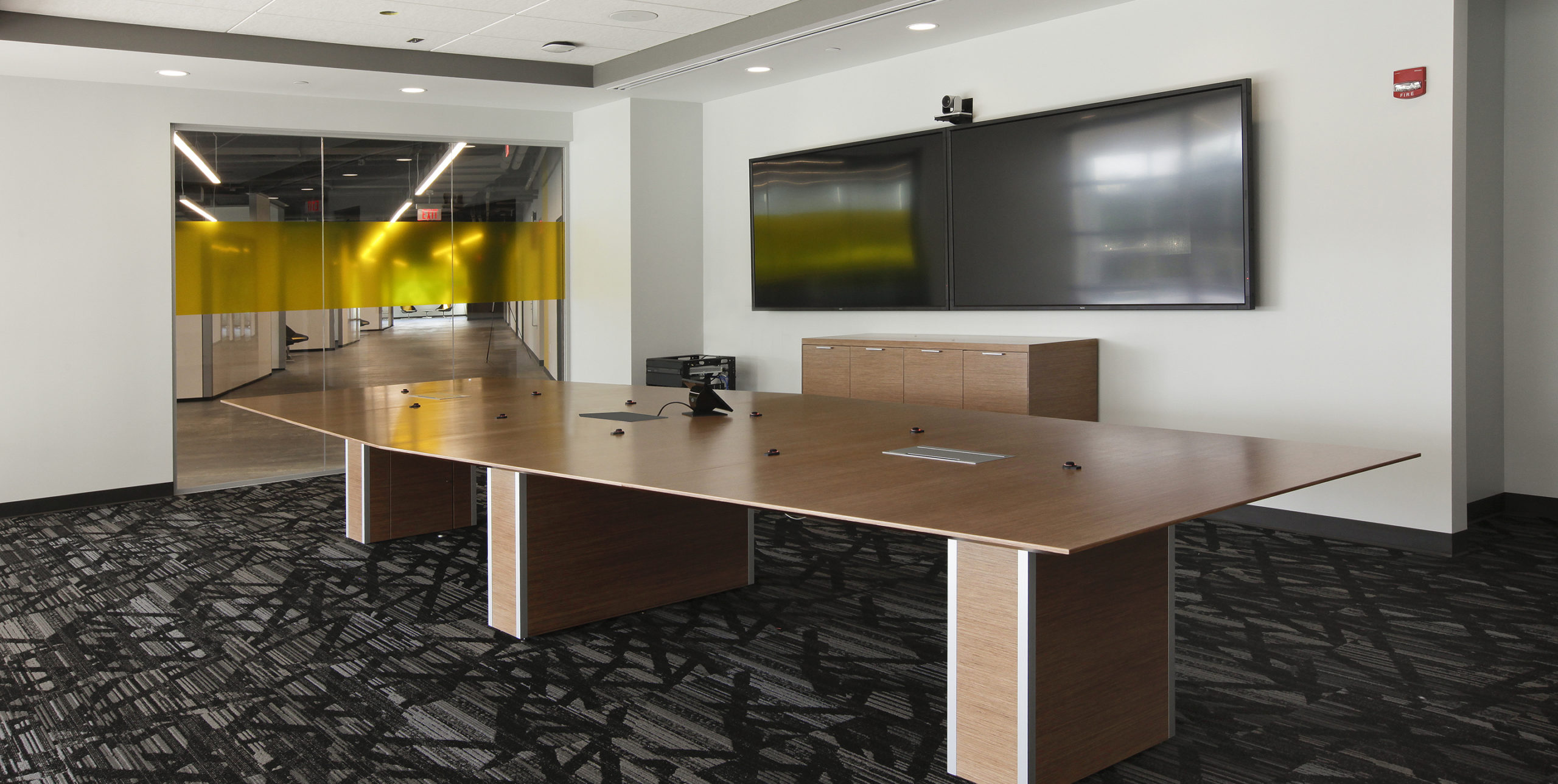 Conference room table with two TVs at Dealertrack Technologies