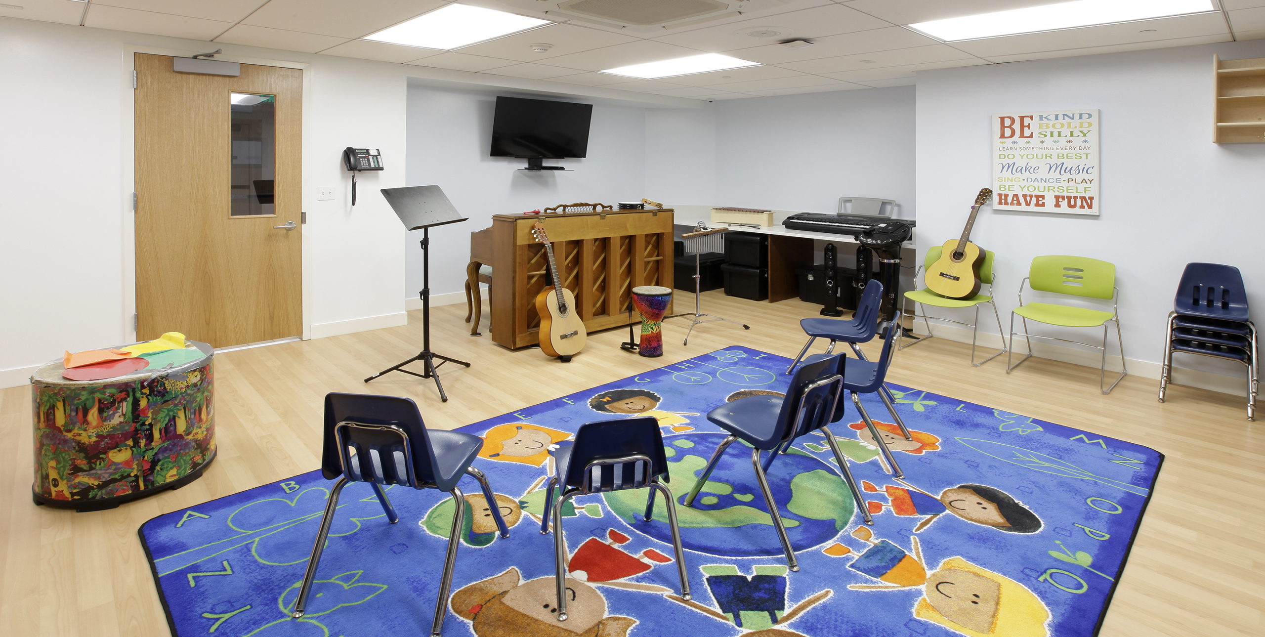 Recreation room with five chairs and musical instruments inside The Family Center For Autism in Garden City