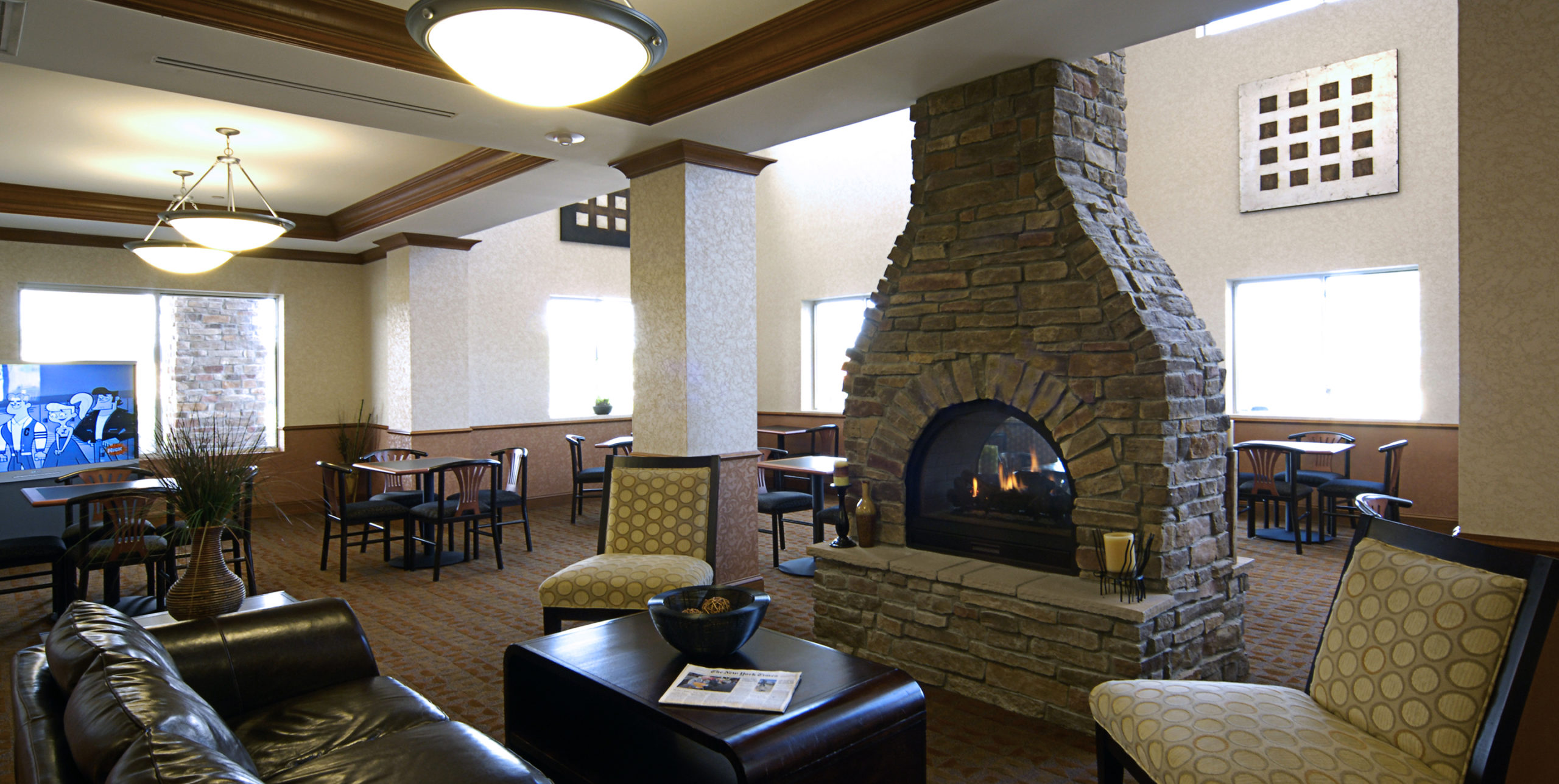 Cafe seating in front of a fireplace at Holiday Inn Express at 1707 Old Country Road, Riverhead