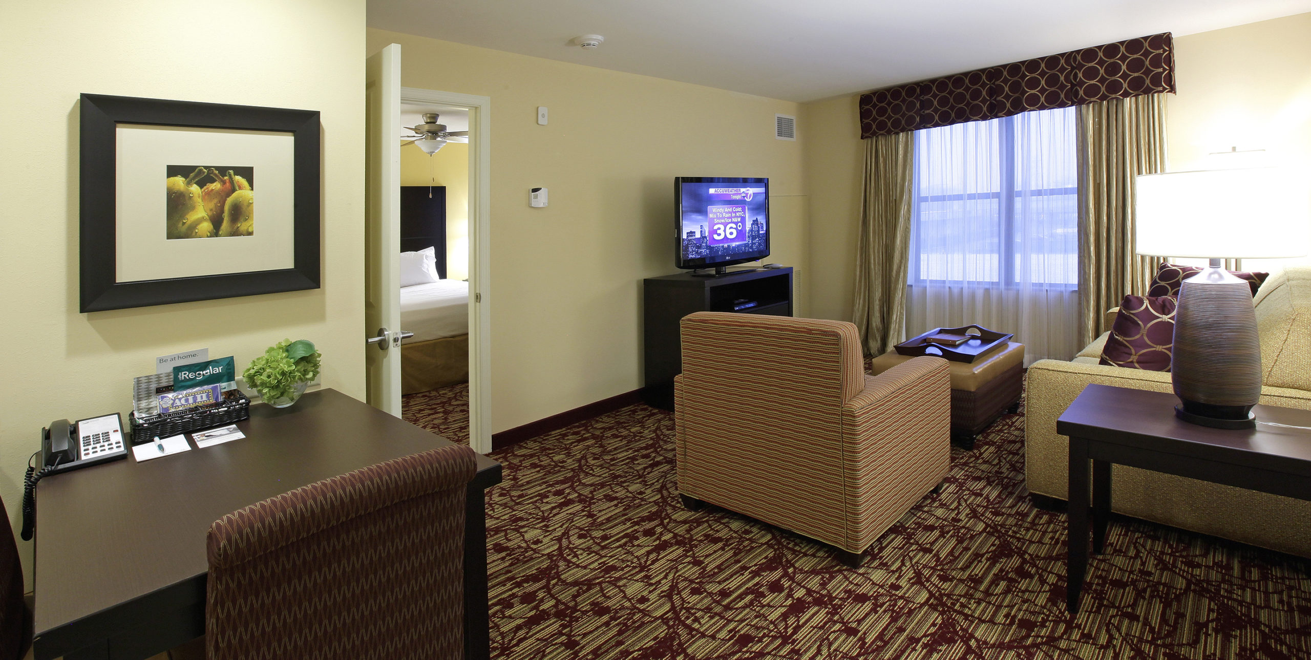 Living room and bedroom area of Homewood Suites at Carle Place