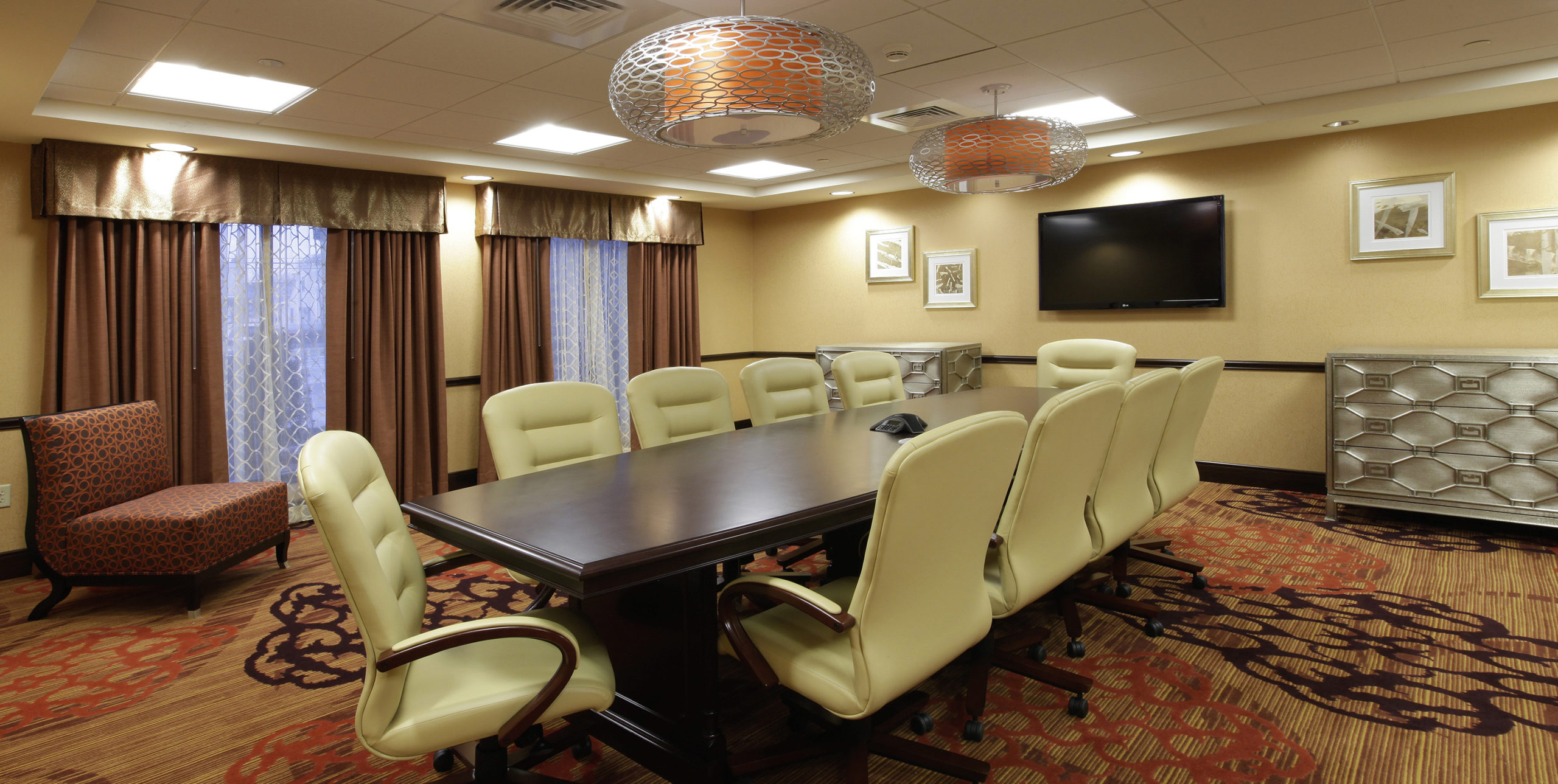 Conference room with ten chairs to a table in Homewood Suites in Carle Place