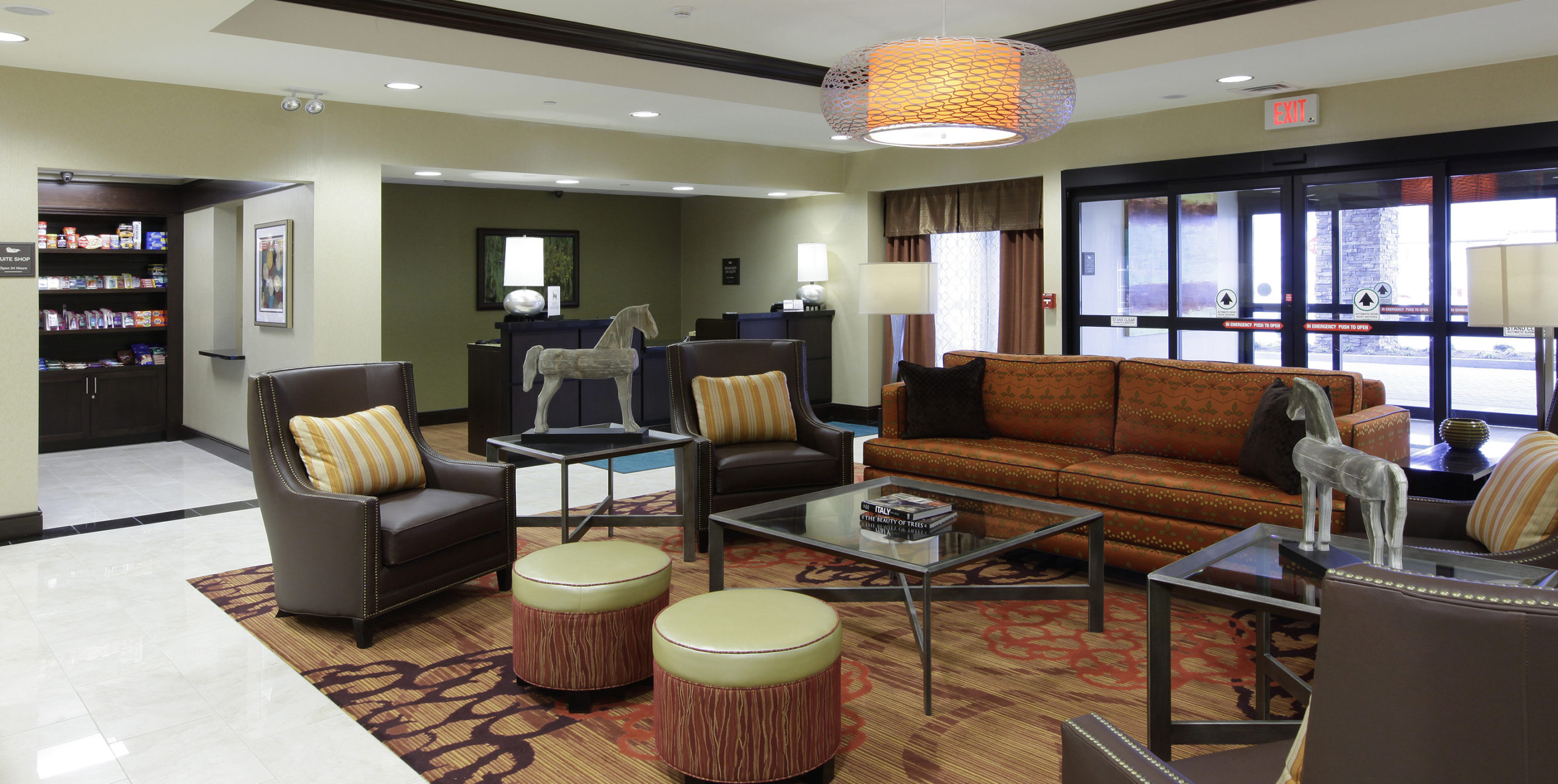 Lobby seating of a couch, chairs, and stools at Homewood Suites in Carle Place