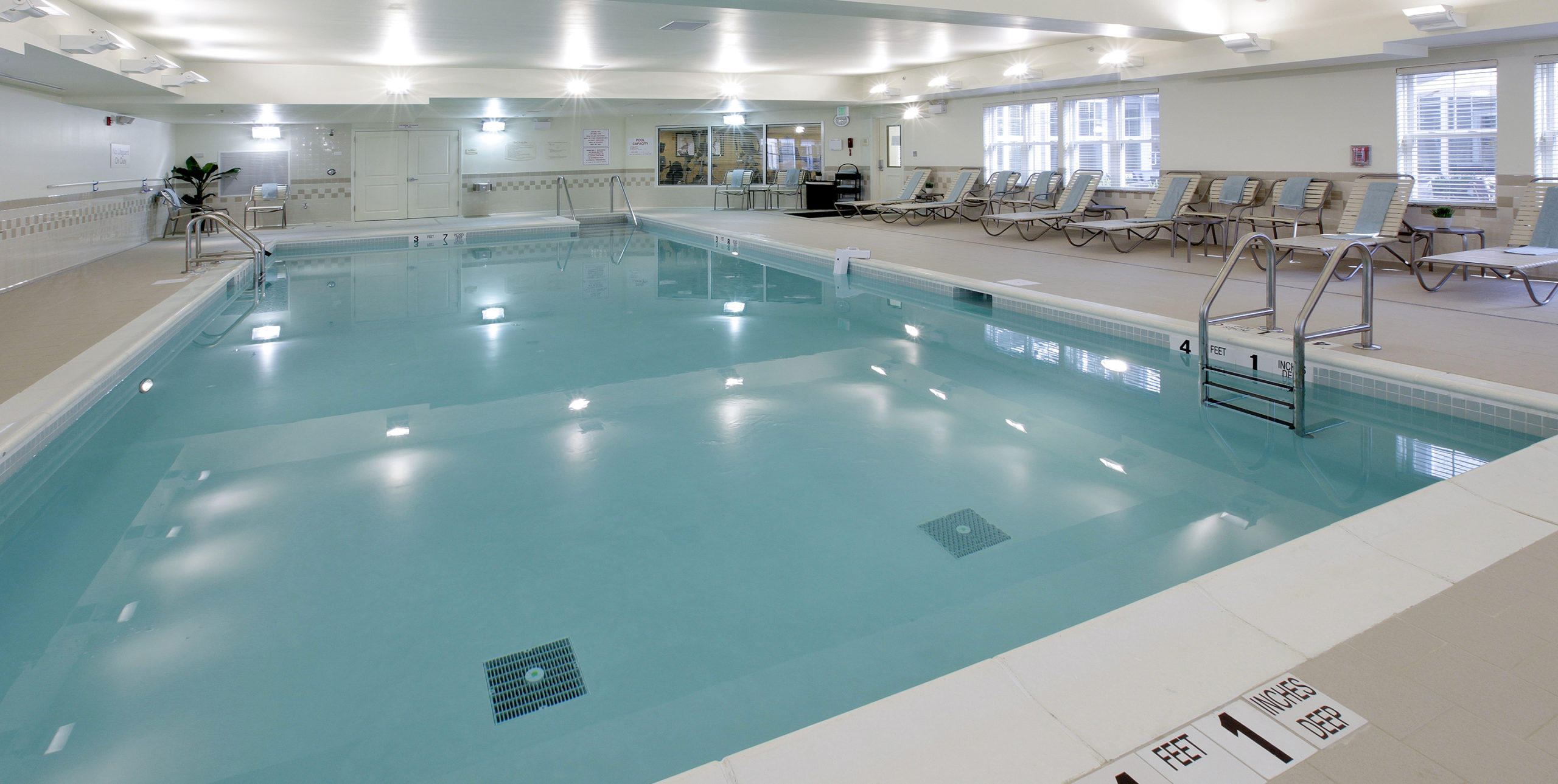 Indoor pool area with lounge seating at Residence Inn by Marriott in Yonkers