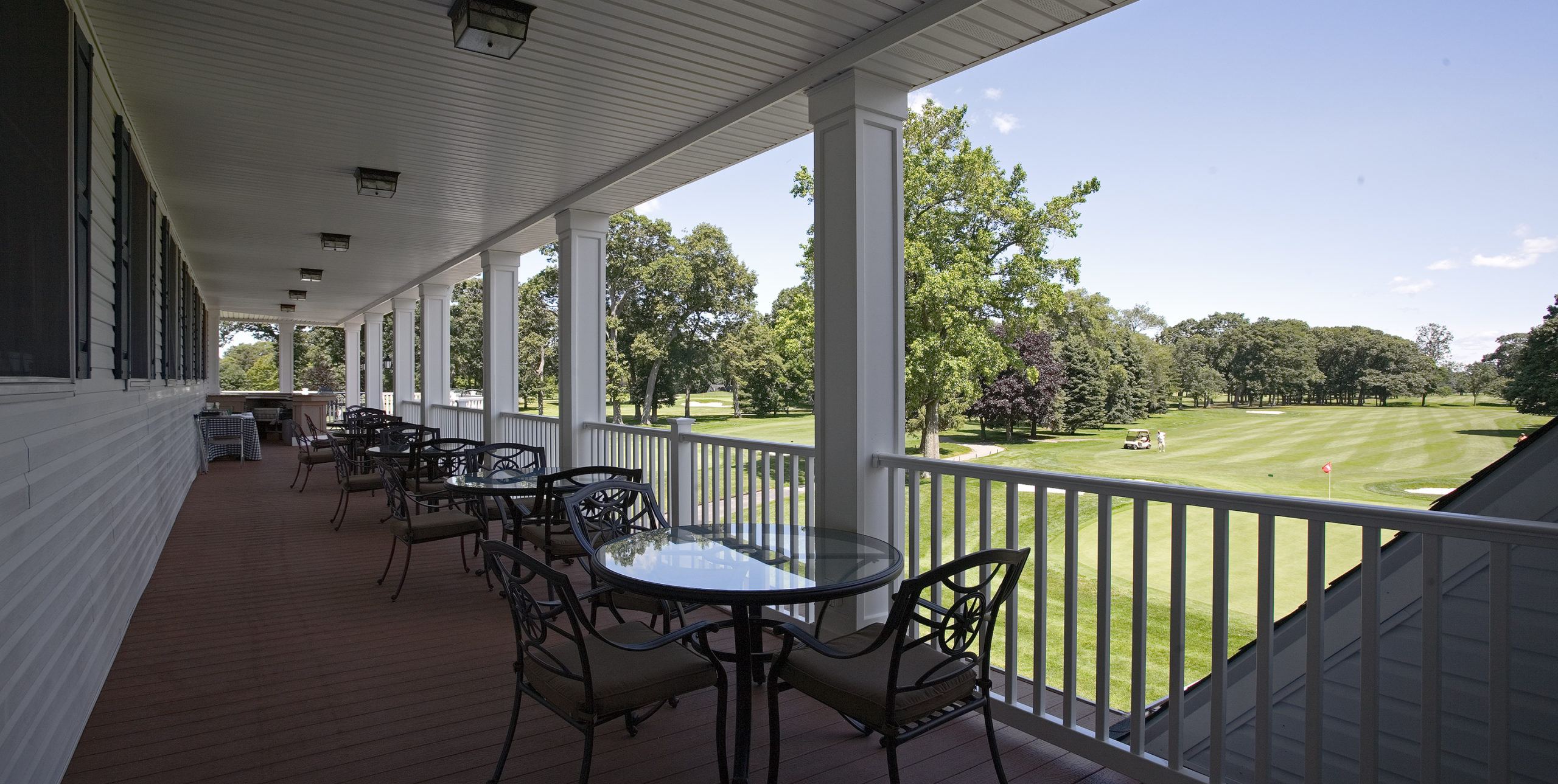 Rockville Links Golf Club exterior seating with four sets of tables with three chairs