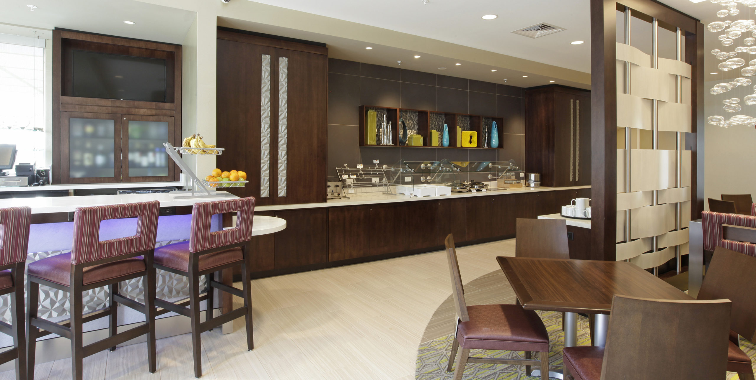 Food court with various seating arrangements at Spring Hill Suites by Marriott in Carle Place