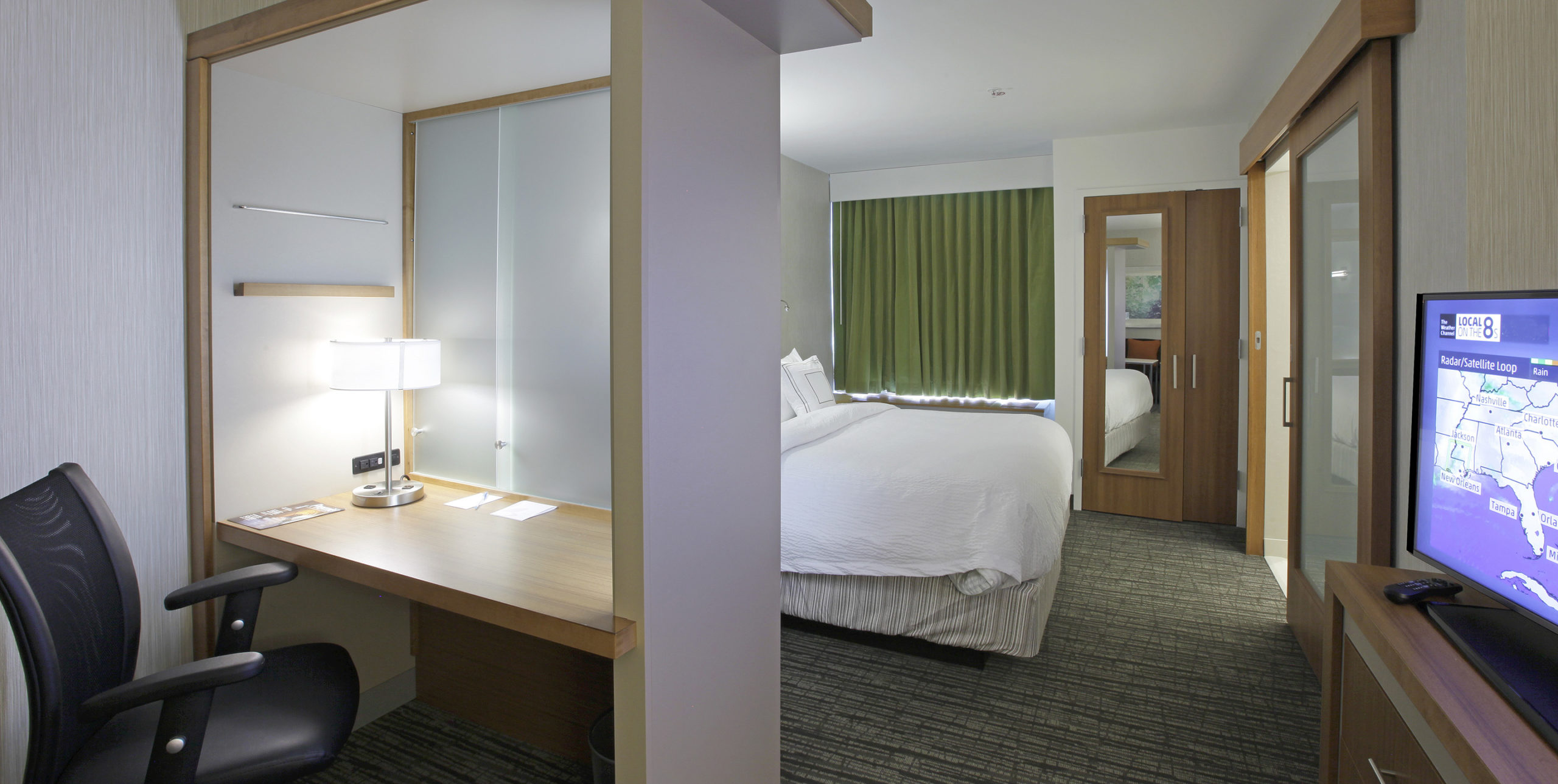 Spring Hill Suites by Marriott queen sized-room with desk and TV in Carle Place