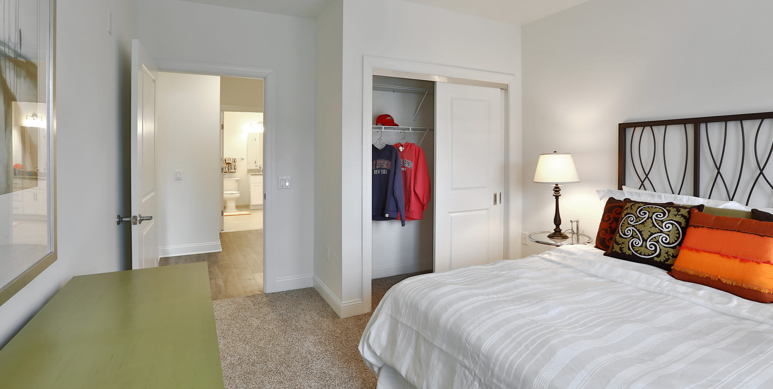 queen-sized bed, closet, and armoire inside a bedroom of an apartment at The Shipyard at Port Jeff Harbor