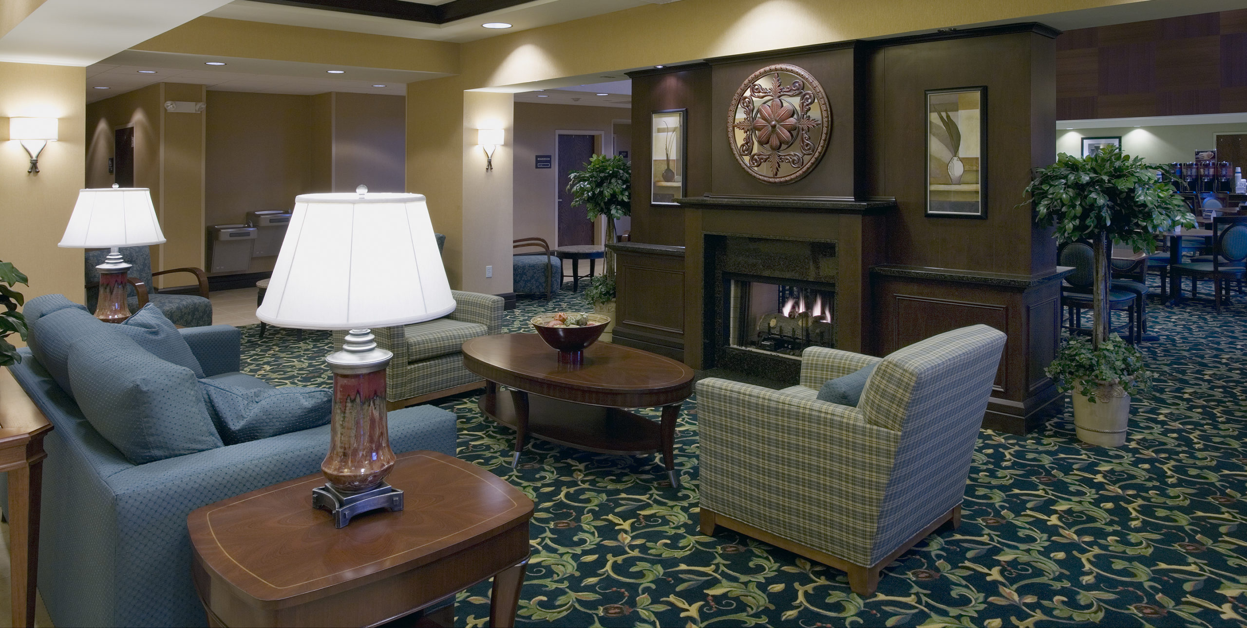 Common seating in front of a fireplace at Hampton Inn at 1 North Avenue, Garden City, NY