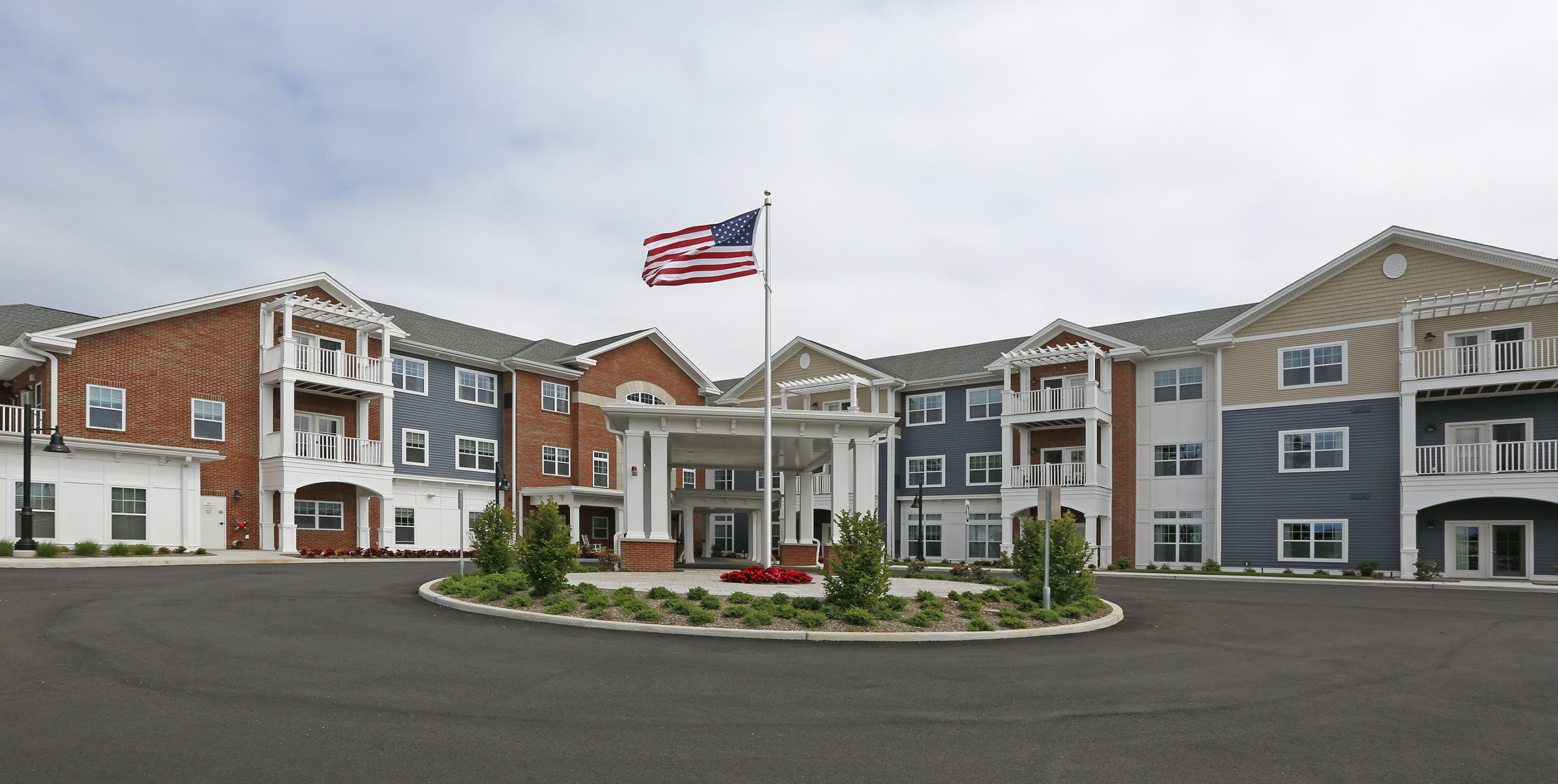 American flag waving high outside of Brightview Senior Living in Sayville, NY
