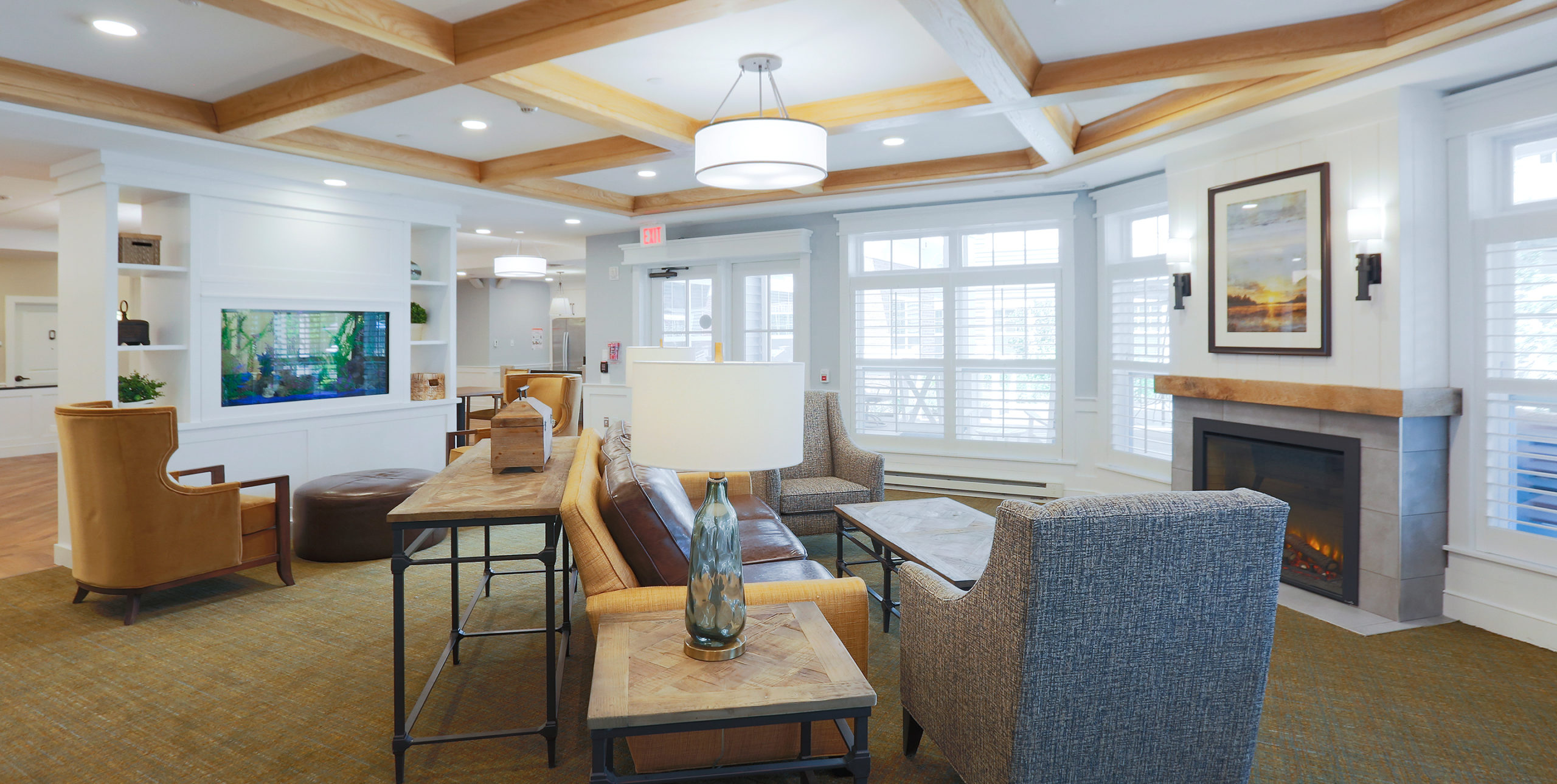 Common area showcasing couches and chairs around a fireplace at Brightview Senior Living in Sayville, NY