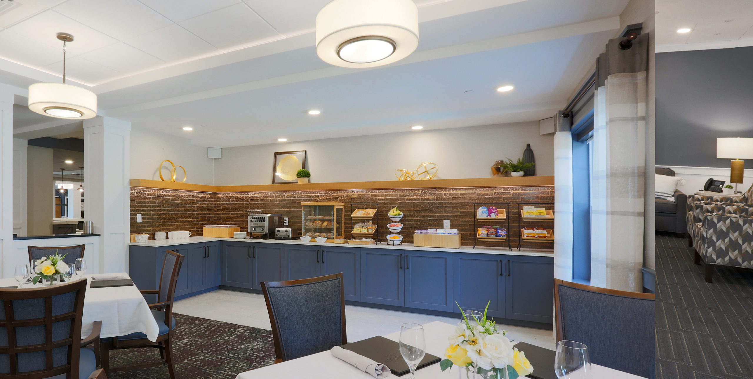 Dining room area with pastries and condiments lined on the counter at Brightview Senior Living in Sayville, NY