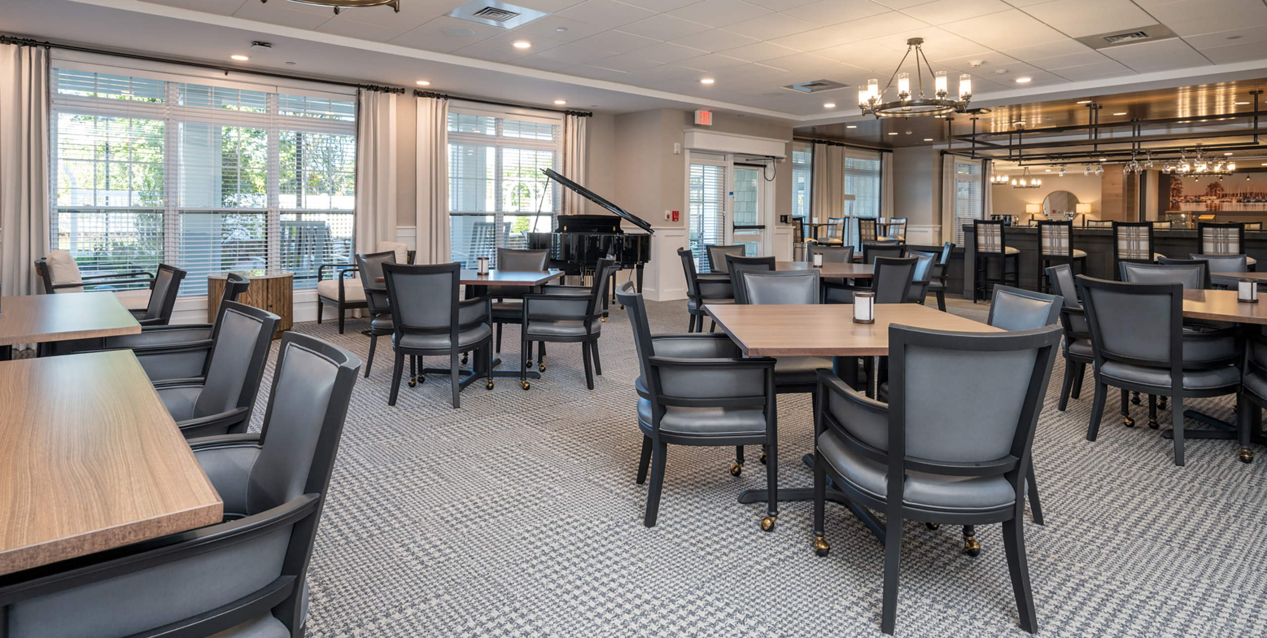 Dining room area with a grand piano at Brightview Senior Living Port Jeff