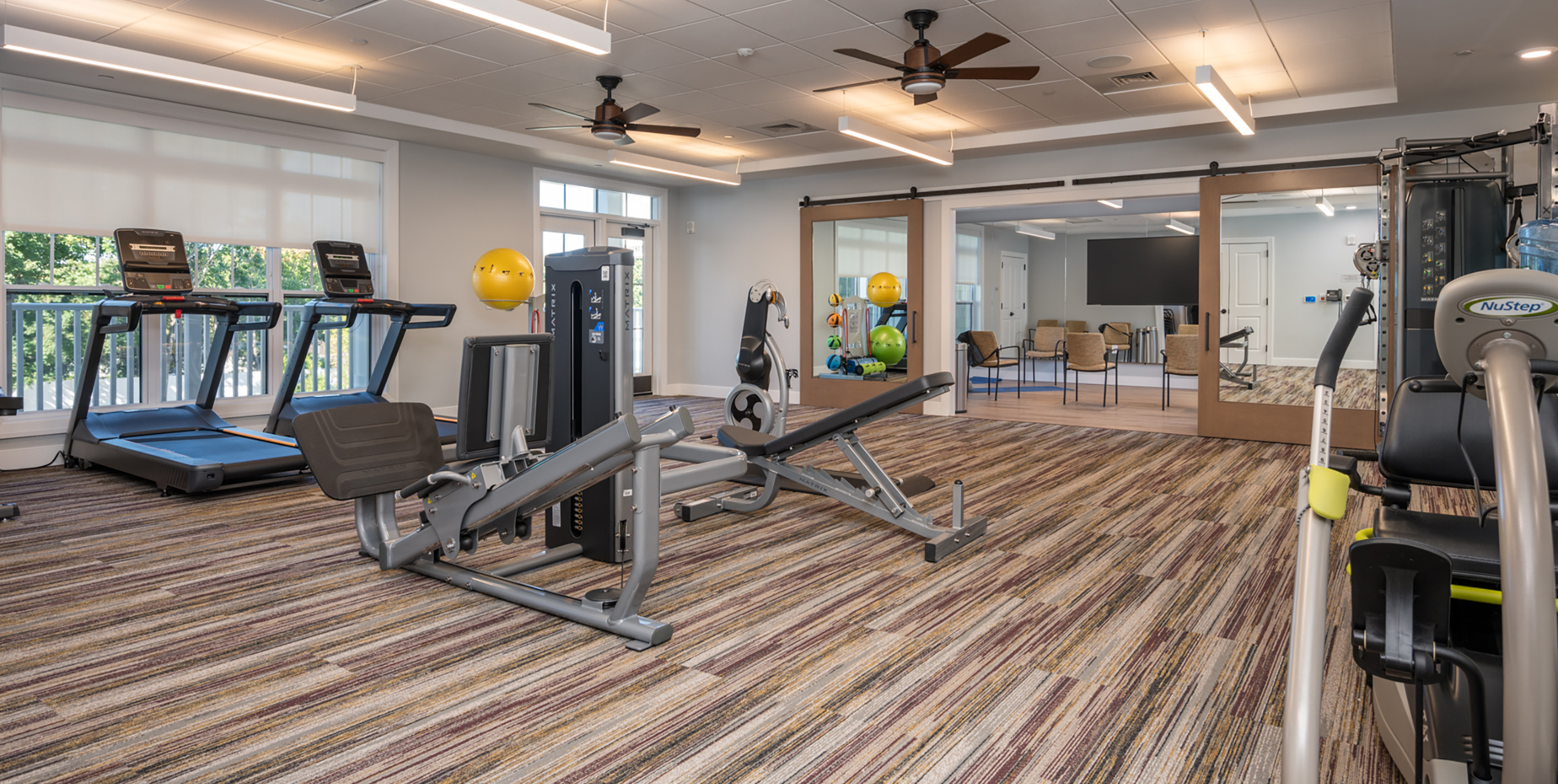 Workout equipment in the gym at Brightview Senior Living Port Jeff