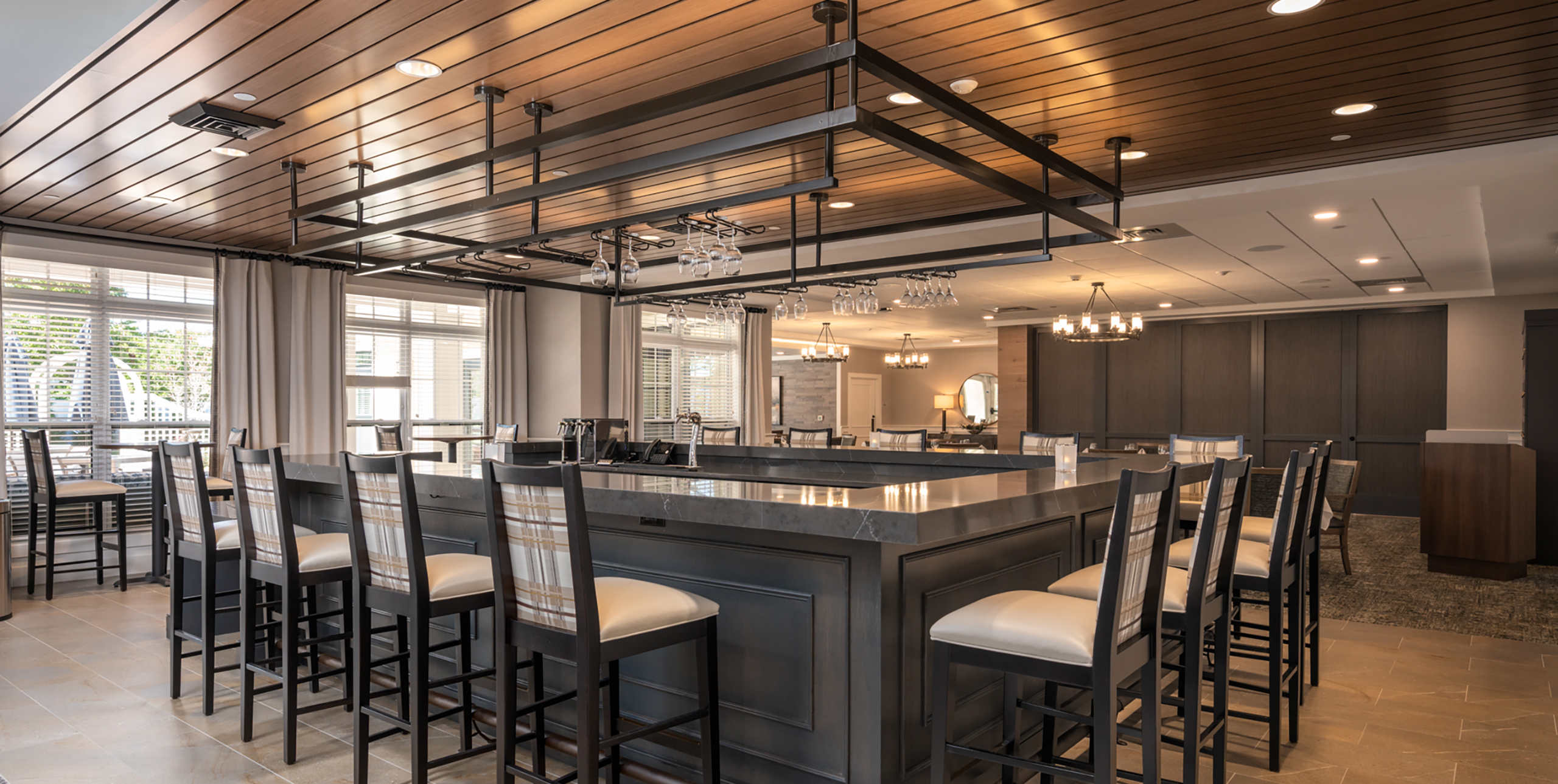 The pub area featuring a bar and barstools at Brightview Senior Living Port Jeff