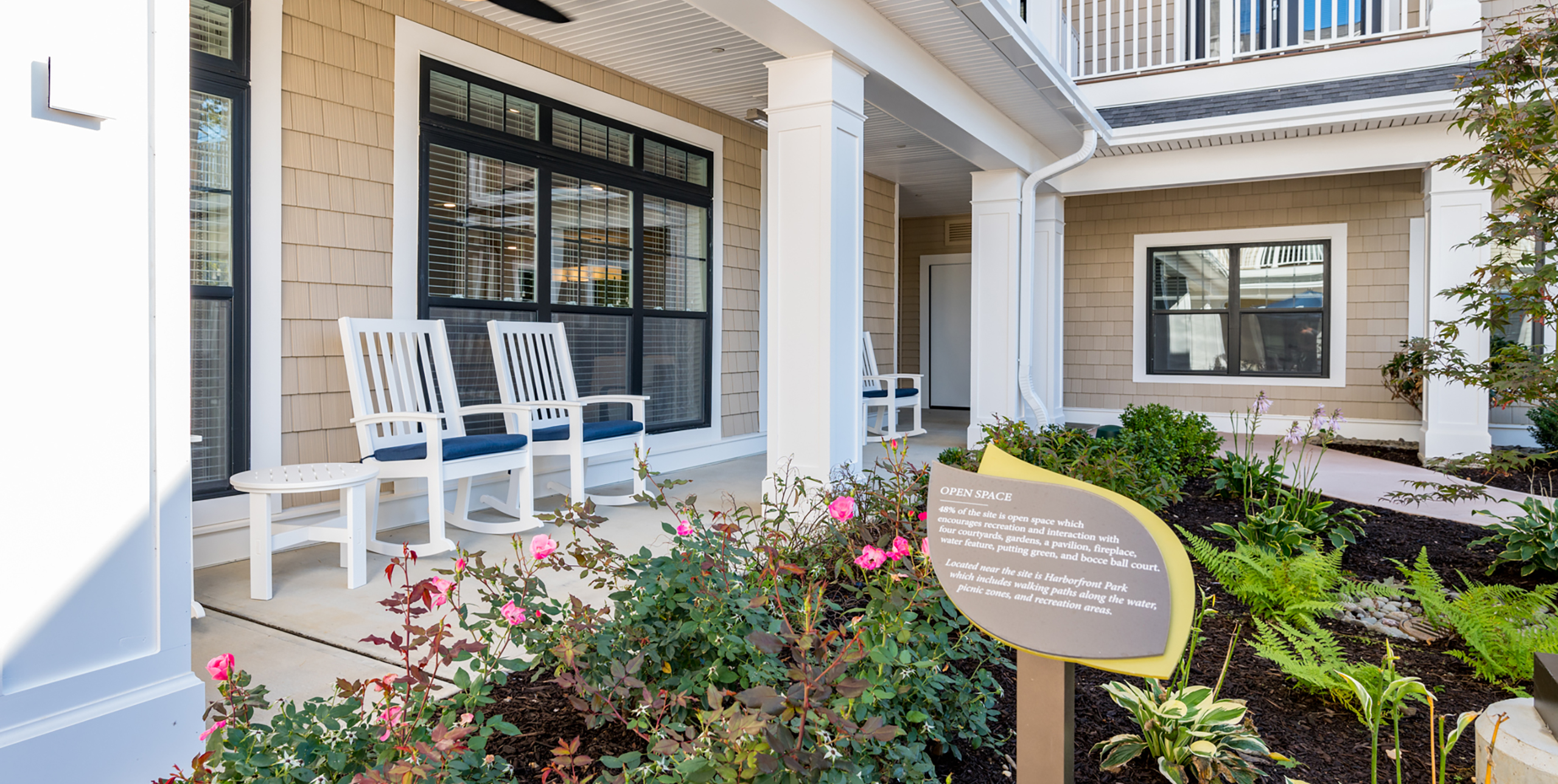 Two rocking chairs outside the front entrance to Brightview Senior Living Port Jeff
