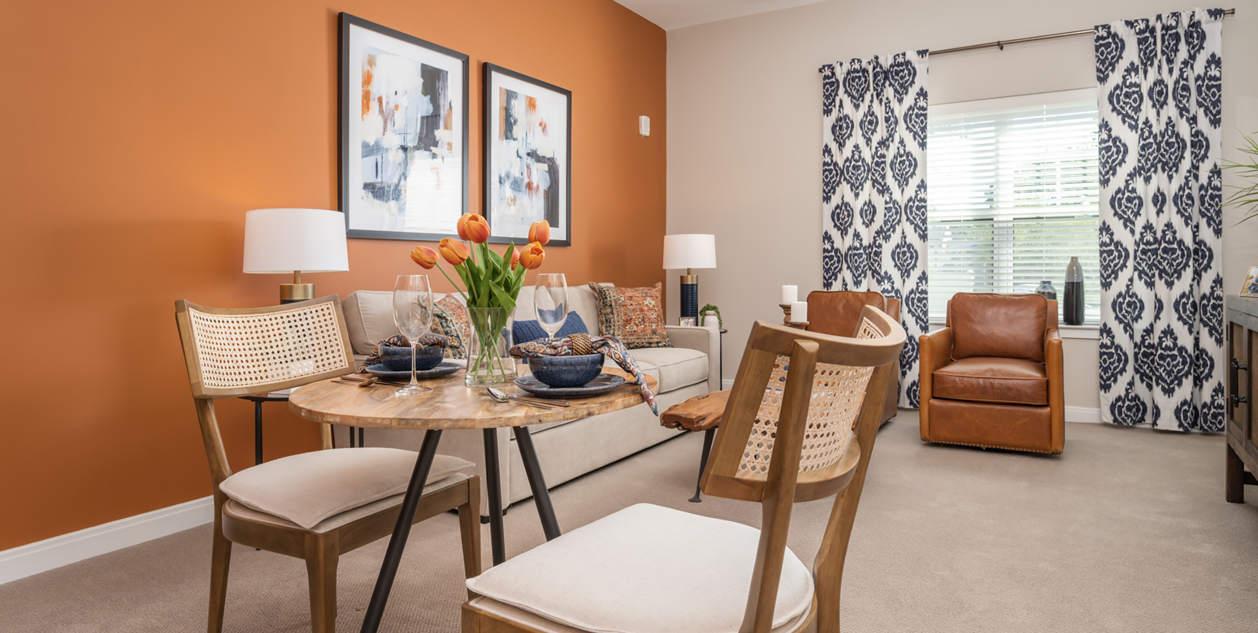 Living room area with dining table and two chairsinside an apartment at Brightview Senior Living Port Jeff