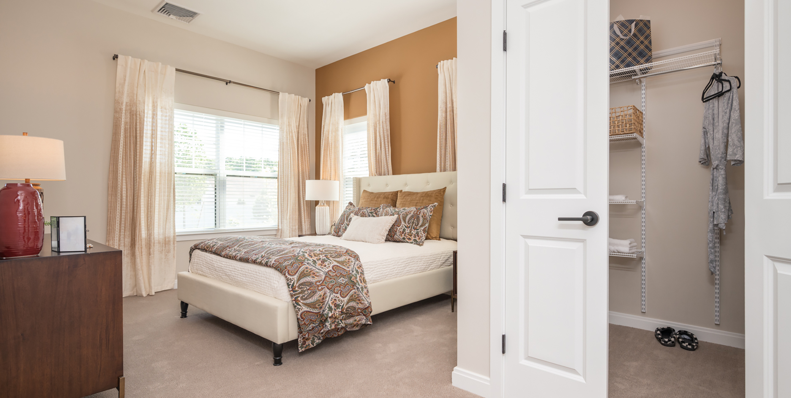 Bedroom with a walk-in closet at an apartment at Brightview Senior Living Port Jeff