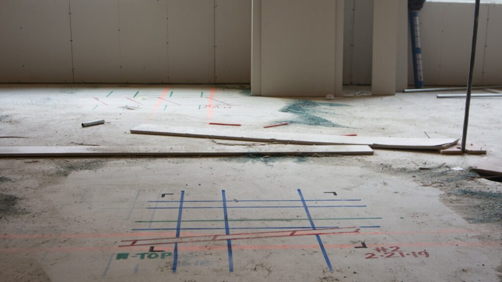 Ground-penetrating radar markings on a concrete floor slab at the Sun River Health Patchogue project